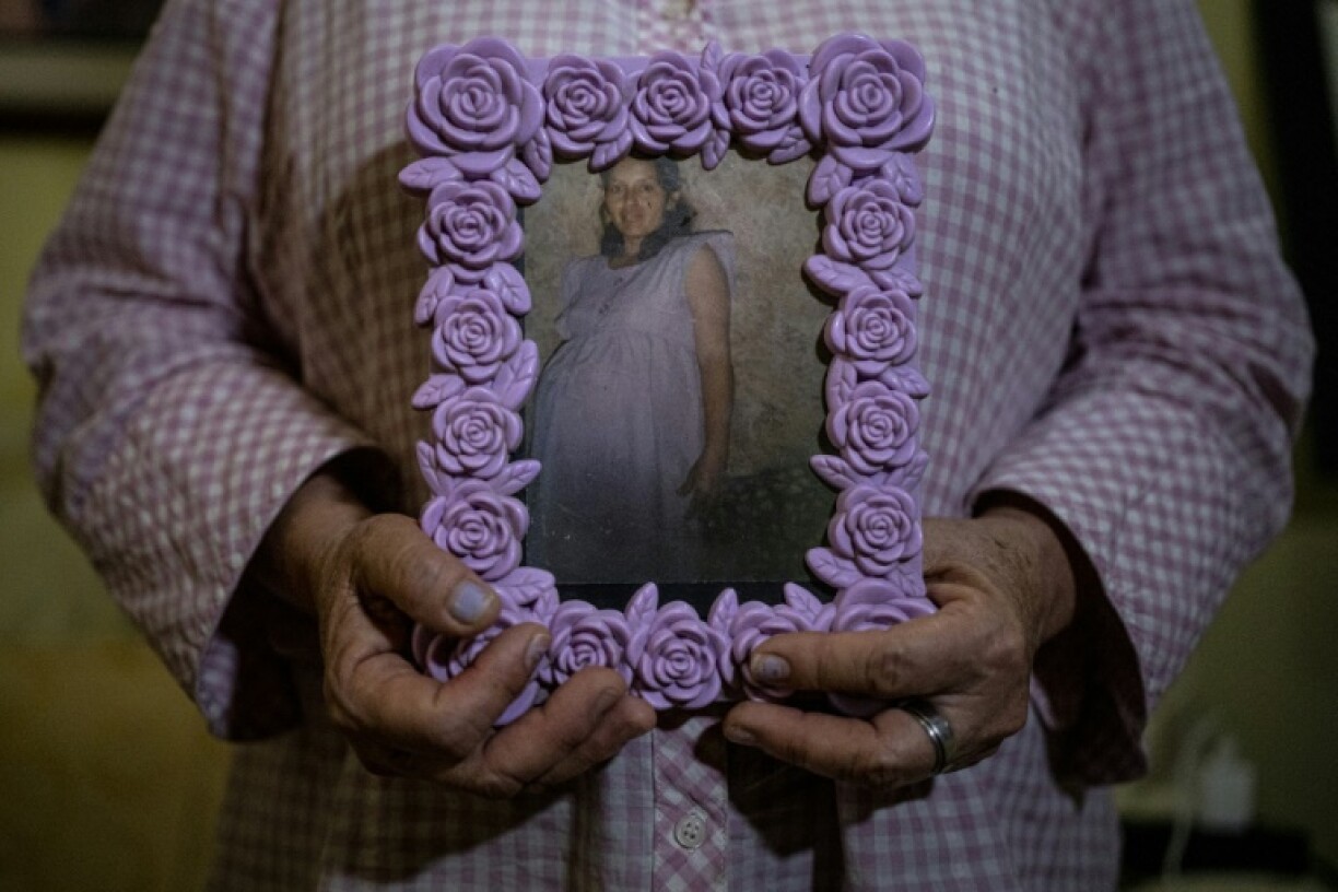 Maria Elena Carbajal with a photo of herself during her last pregnancy before being sterilized against her will
