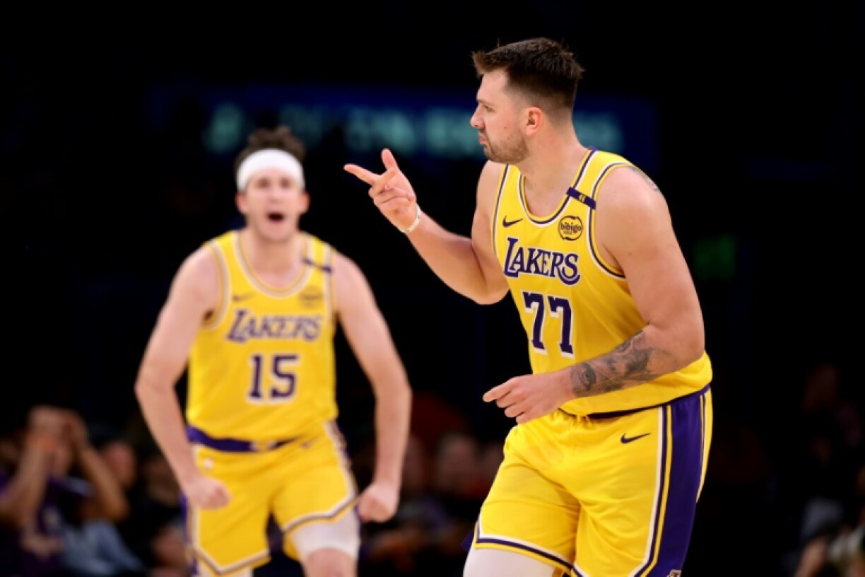 Luka Doncic celebrates a three-pointer with team-mate Austin Reaves in the Los Angeles Lakers win over Denver