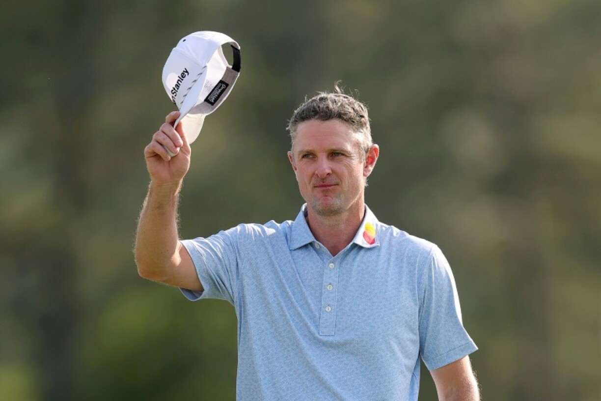 England's Justin Rose salutes fans after taking the first-round lead at the Masters at Augusta National