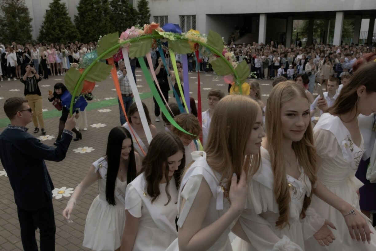 Boys in suits led girls to a waltz in the school's courtyard