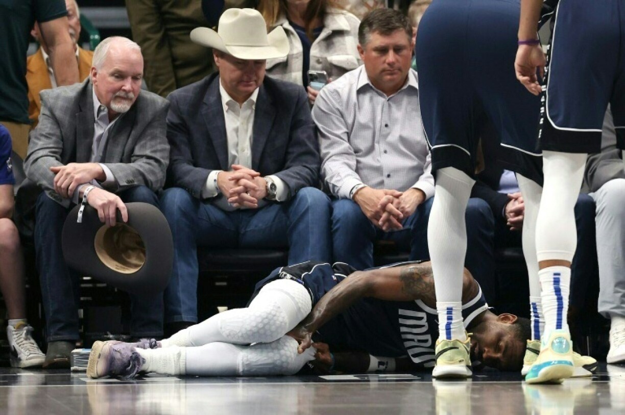 Kyrie Irving of the Dallas Mavericks lies on the court after suffering an injury in the first half against the Sacramento Kings on Monday
