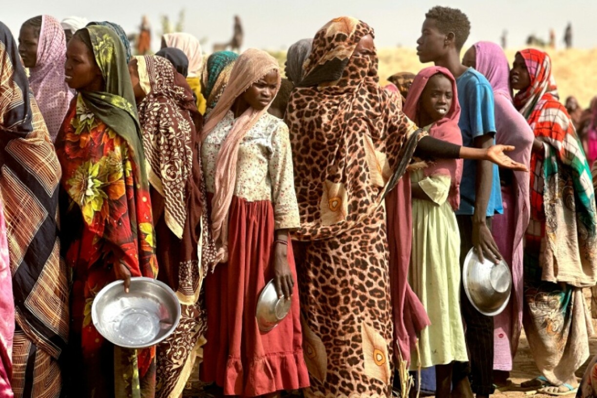 People who fled the Zamzam camp for the internally displaced after it fell under RSF control waiting for food rations at a makeshift encampment in western Darfur