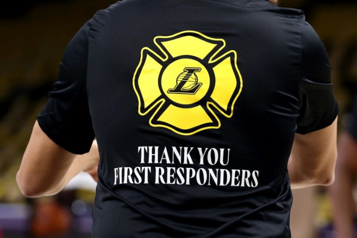 A member of the Los Angeles Lakers wears a shirt thanking first responders battling wildfires that have ravaged the city prior to an NBA game against the San Antonio Spurs