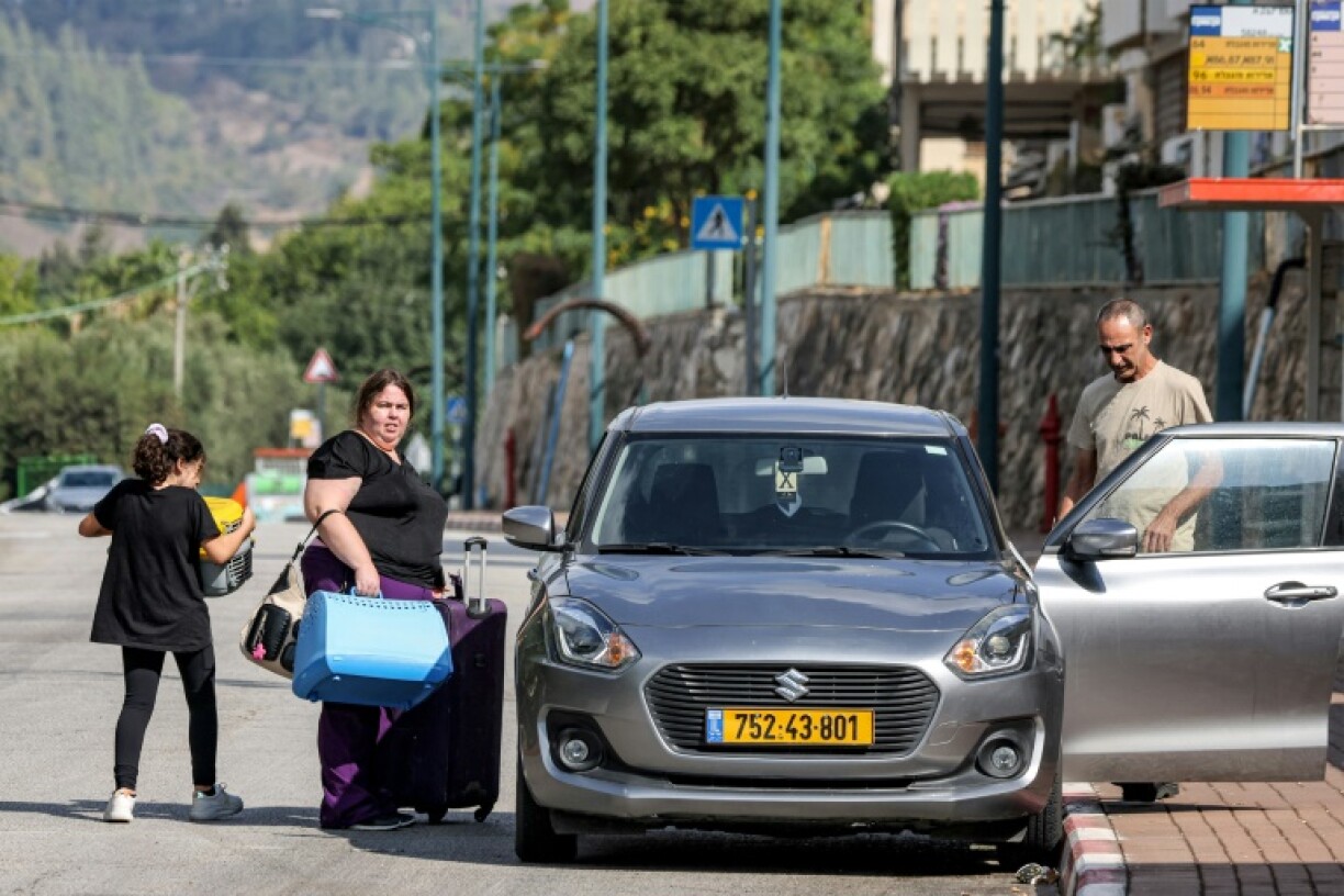 Residents evacuate the town of Kiryat Shmona in northern Israel, near the border with Lebanon, on 19 October.