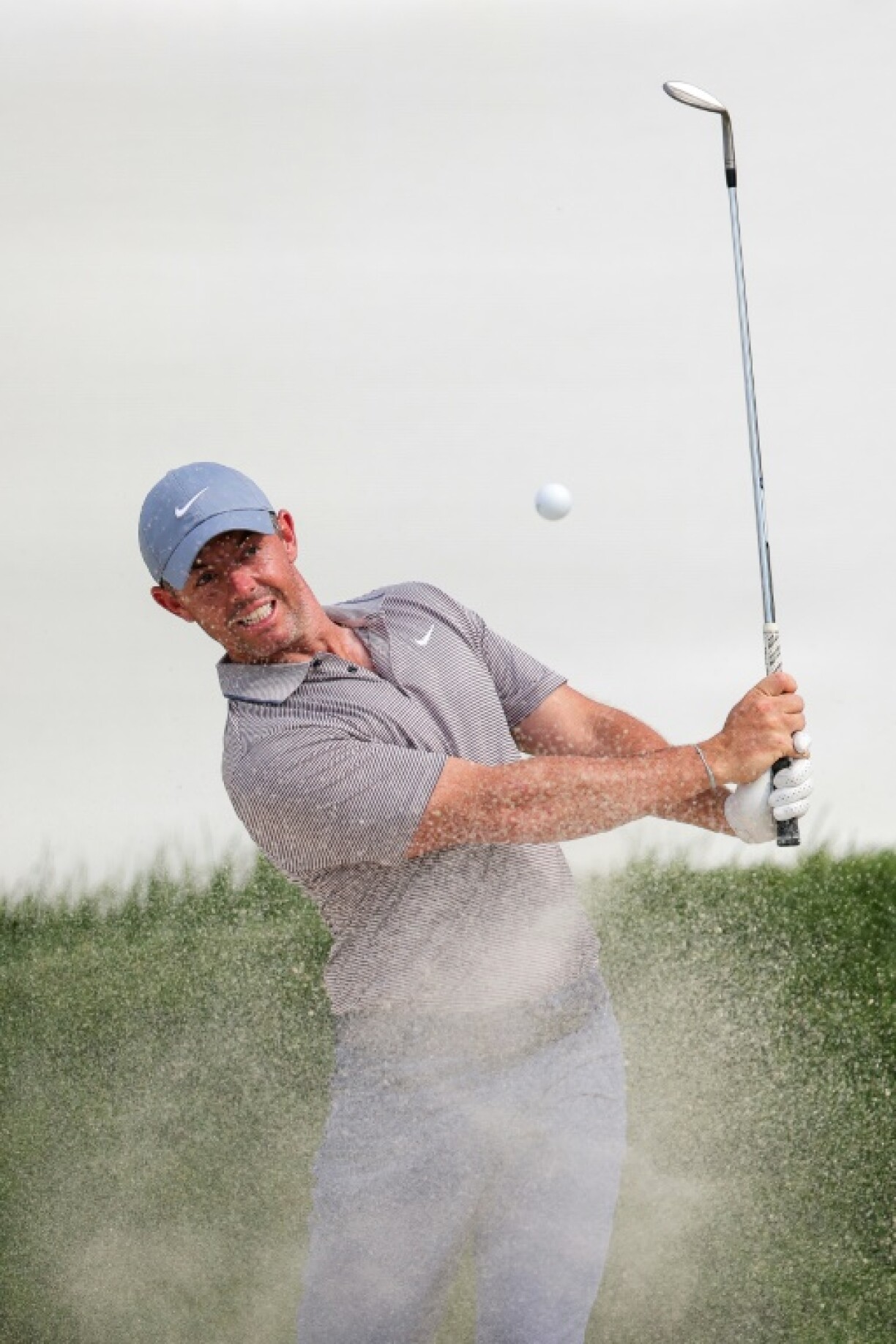 Defending champion Rory McIlroy of Northern Ireland hits out of a greenside bunker in the first round of the PGA Tour Truist Championship