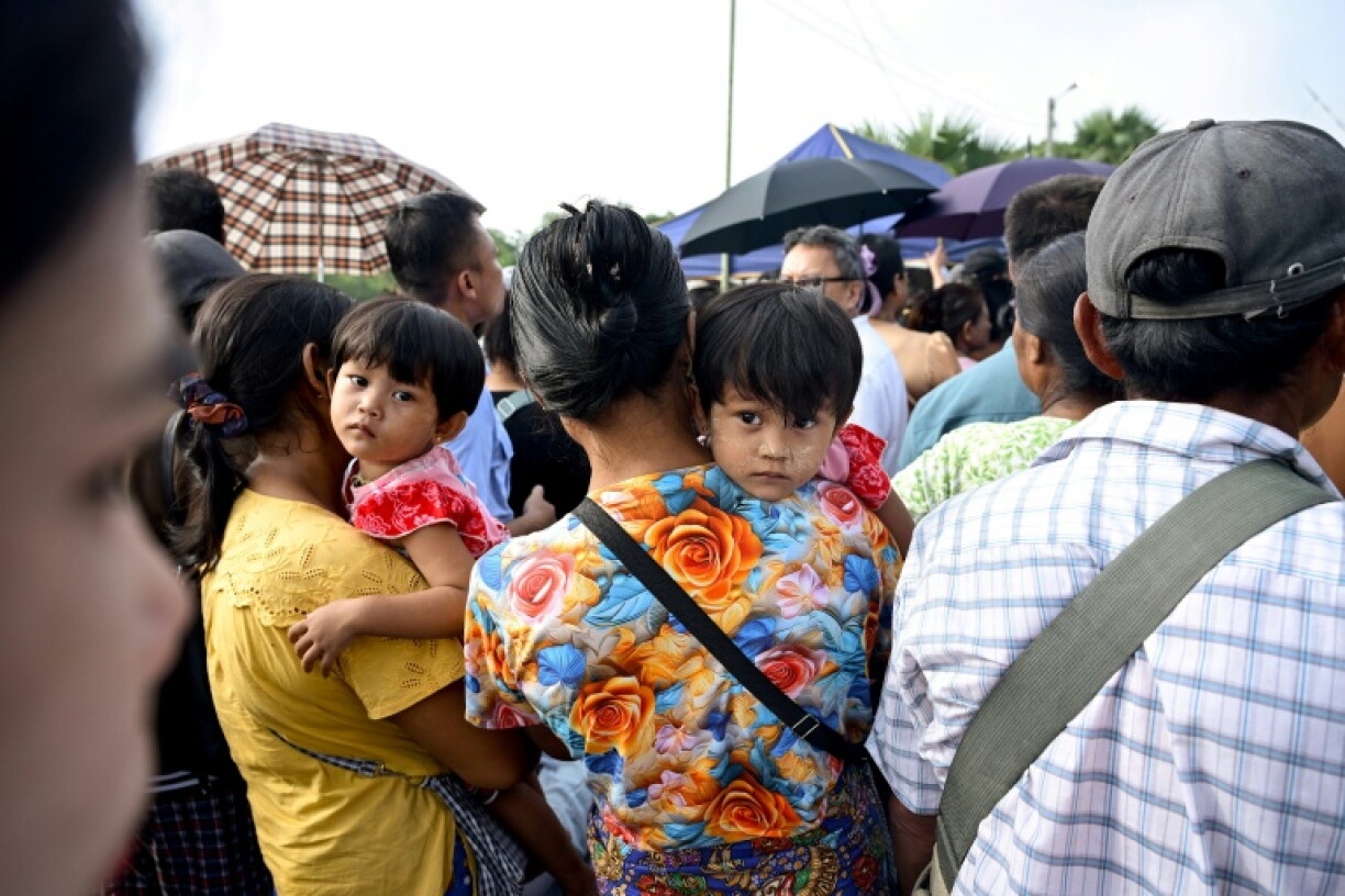 Many families who had gathered outside the base were told they would have to wait to see their relatives who would be transported to different parts of the Yangon region after arriving in Myanmar