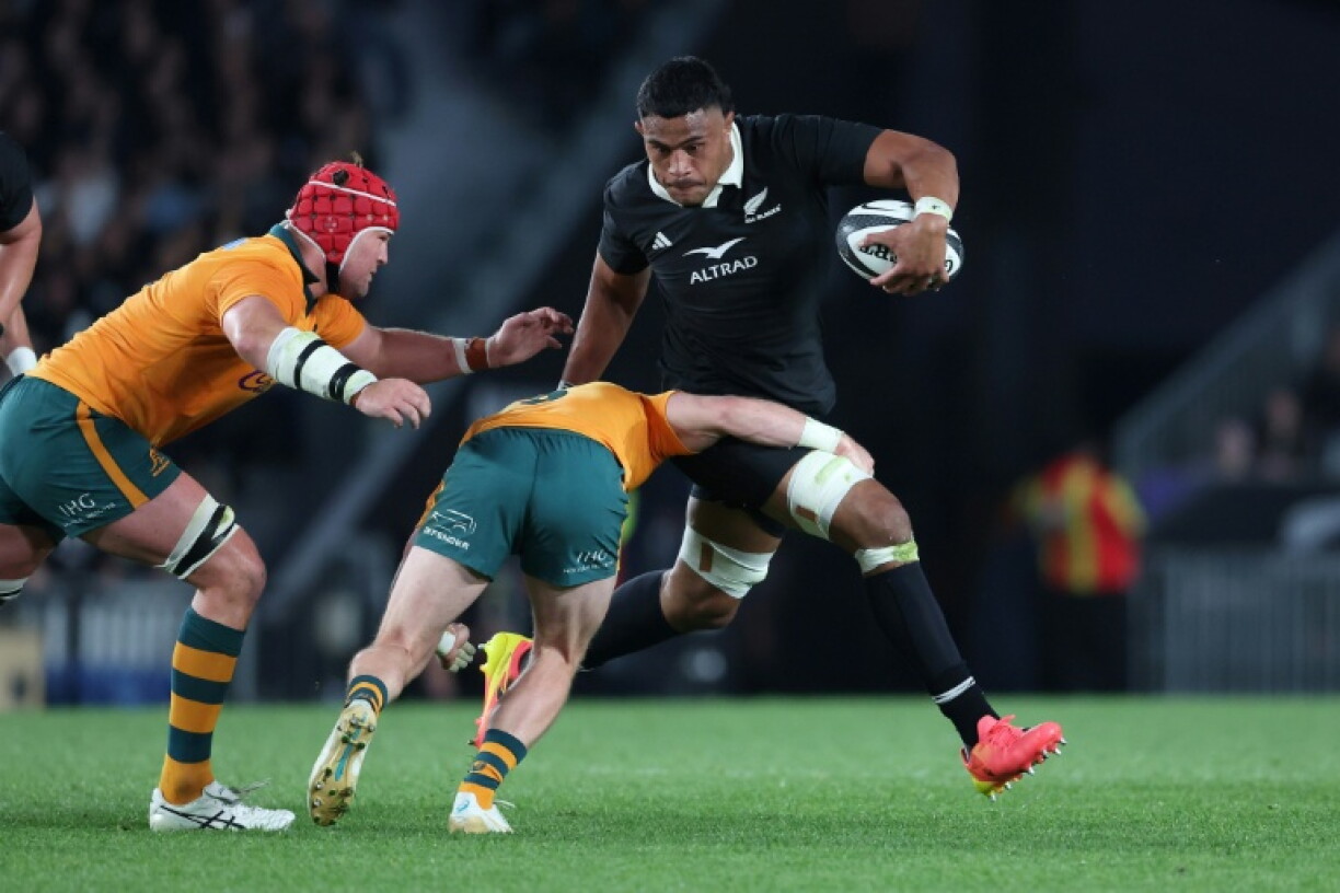Tupou Vaa'i (C) of New Zealand is tackled during the rugby union Bledisloe Cup match between New Zealand and Australia