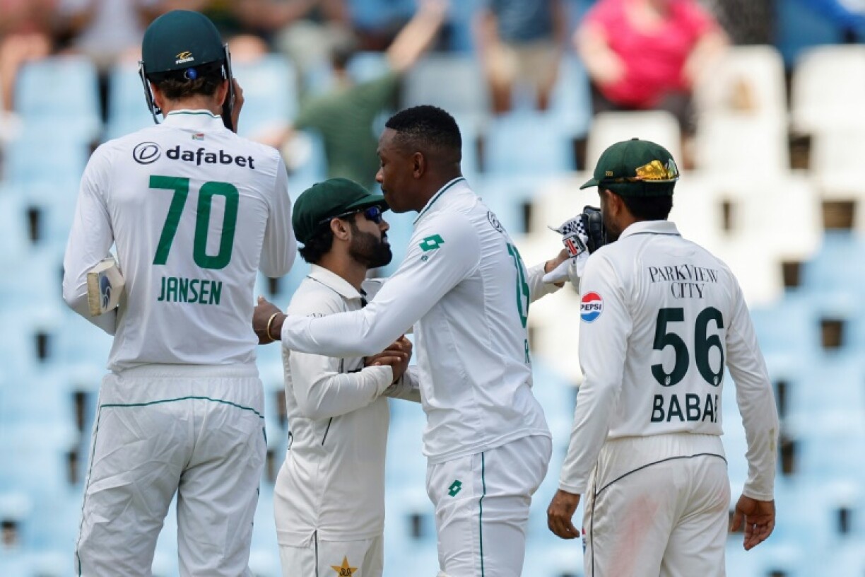 Pakistan's Mohammad Rizwan (CL) congratulates South Africa's Kagiso Rabada (CR) after he steered the hosts to victory in a nailbiting climax to the first Test