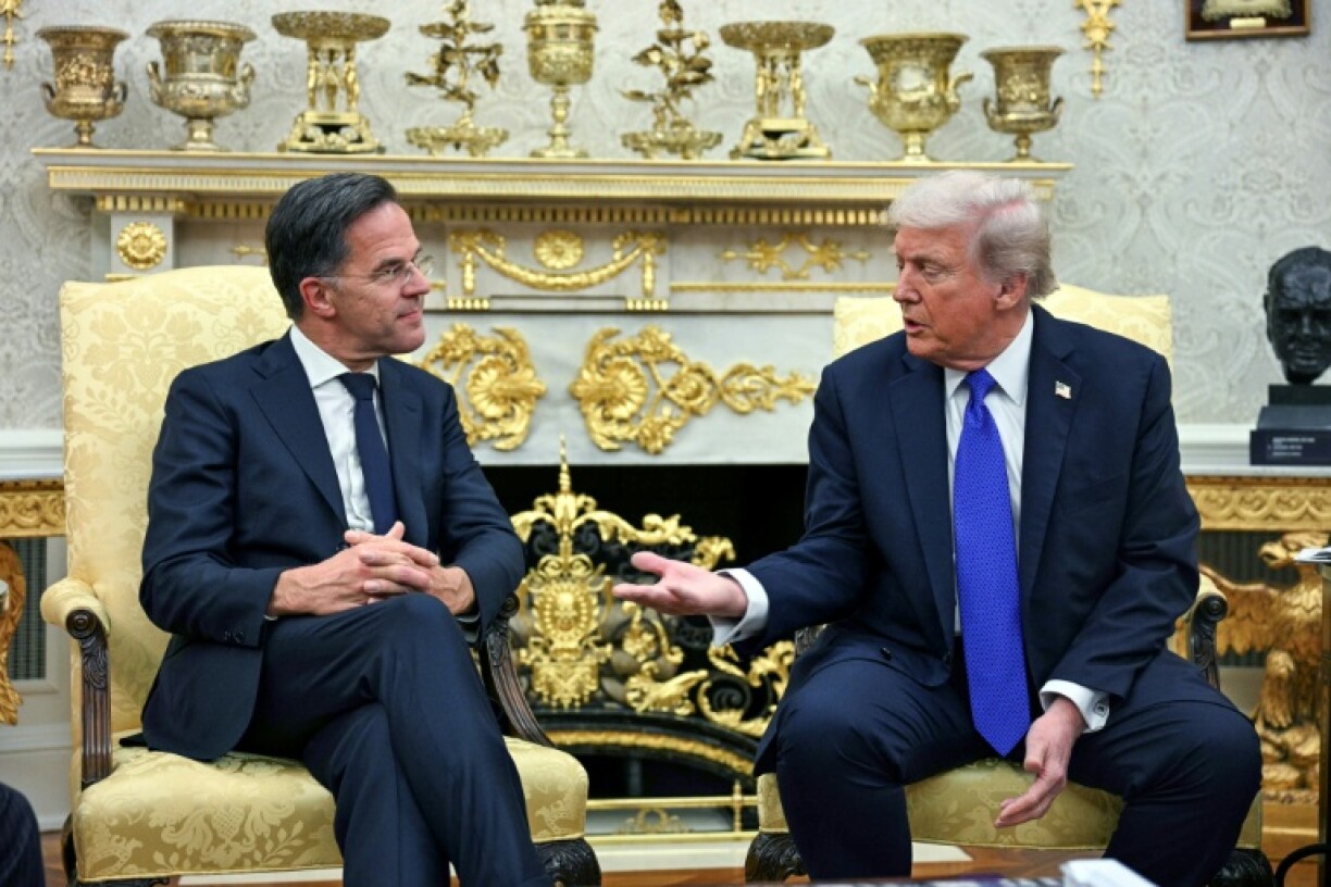 US President Donald Trump talks to NATO Secretary General Mark Rutte (L) during their meeting in the Oval Office of the White House in Washington, DC, on October 22, 2025.