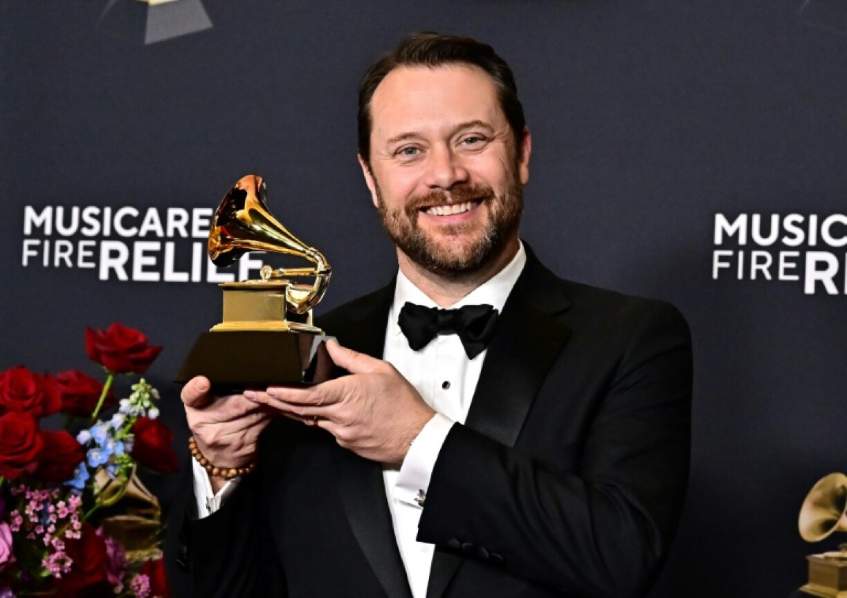 Jason Carter, grandson of former US president Jimmy Carter poses with his grandfather's posthumous Grammy for Best Audiobook, Narration and Storytelling Recording