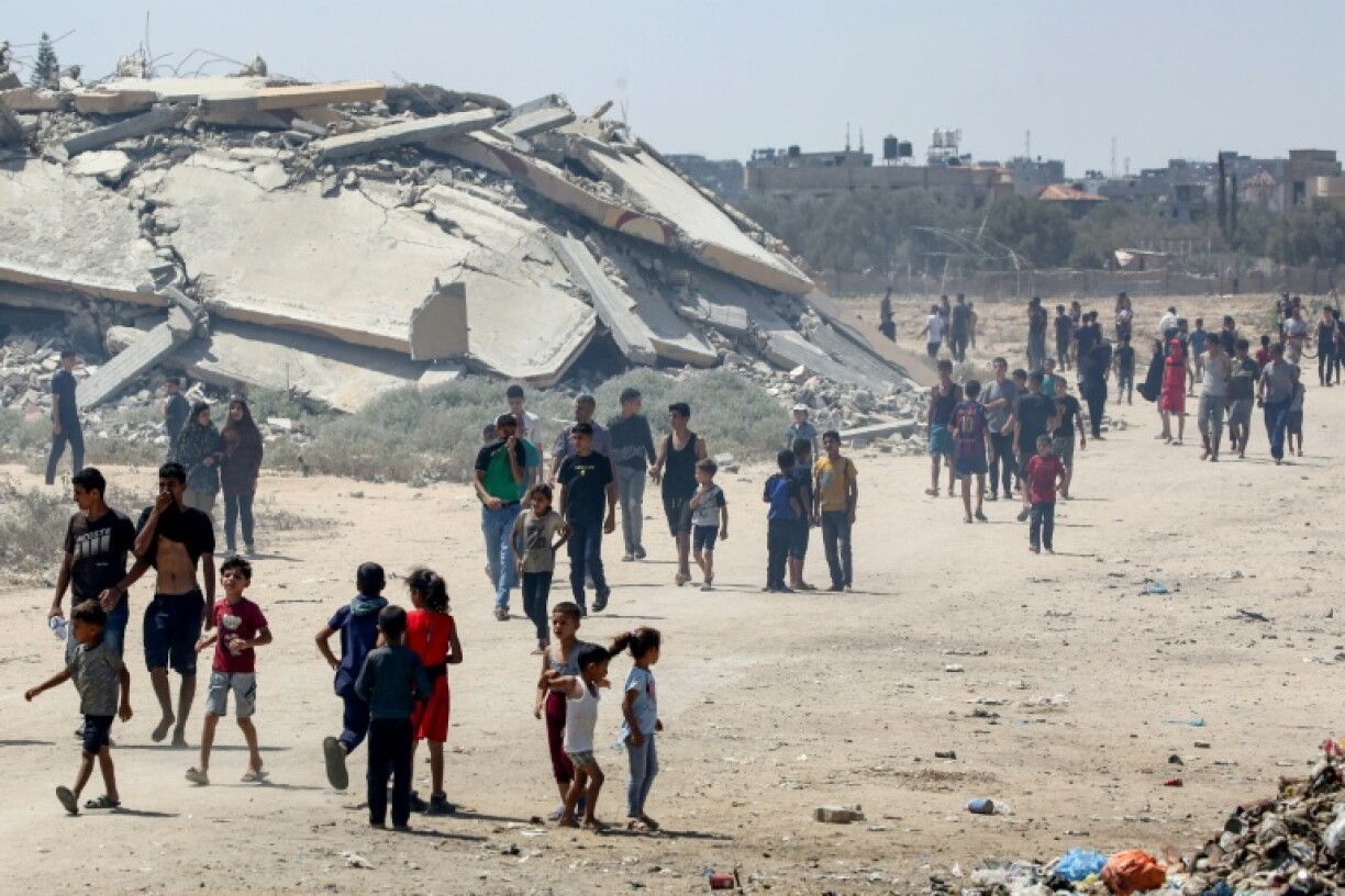 Displaced Palestinians hoping to collect aid from a humanitarian airdrop in the central Gaza Strip