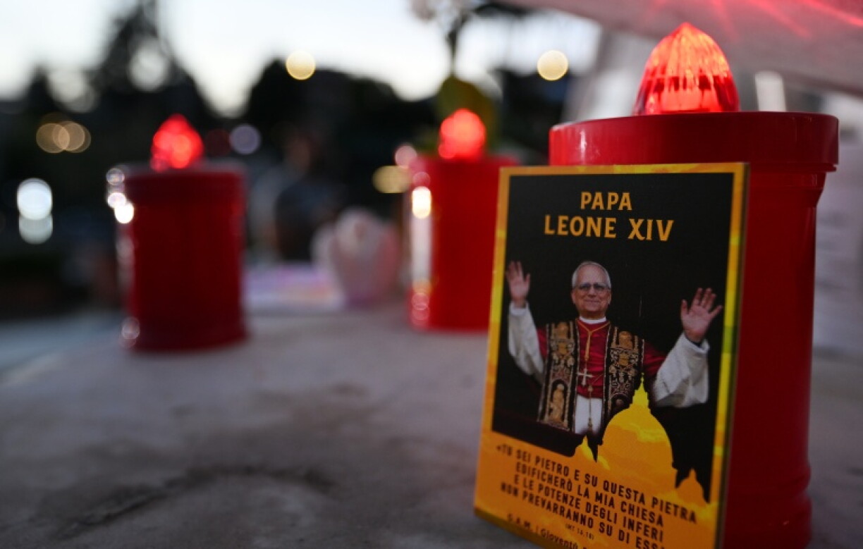 A picture of Pope Leo XIV and candles are laid outside the Gemelli University Hospital in Rome, where he is recovering after surgery to remove a cancerous tumour from his right lung