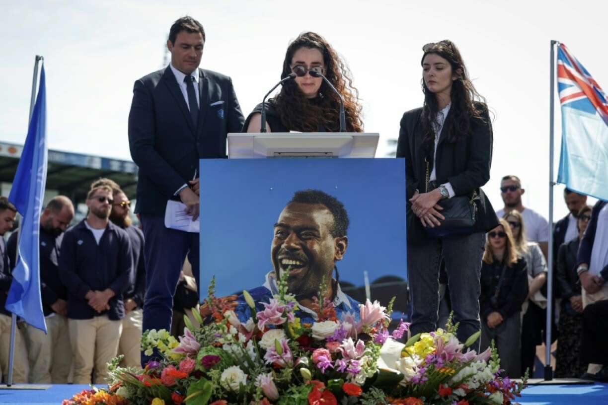 Josaia Raisuqe's partner Ilona (C) adresses the crowd at the ceremony in Castres to pay tribute to the Fiji wing