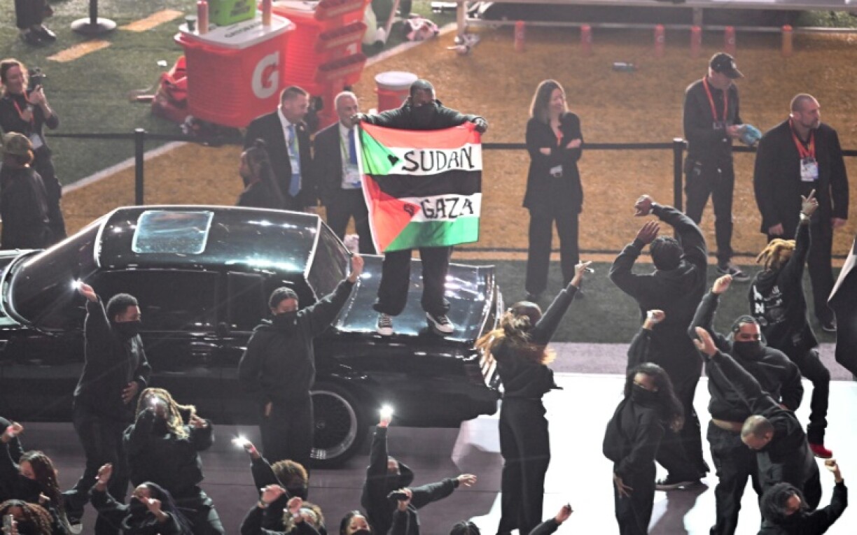 A protestor holds a Palestinian flag with the words