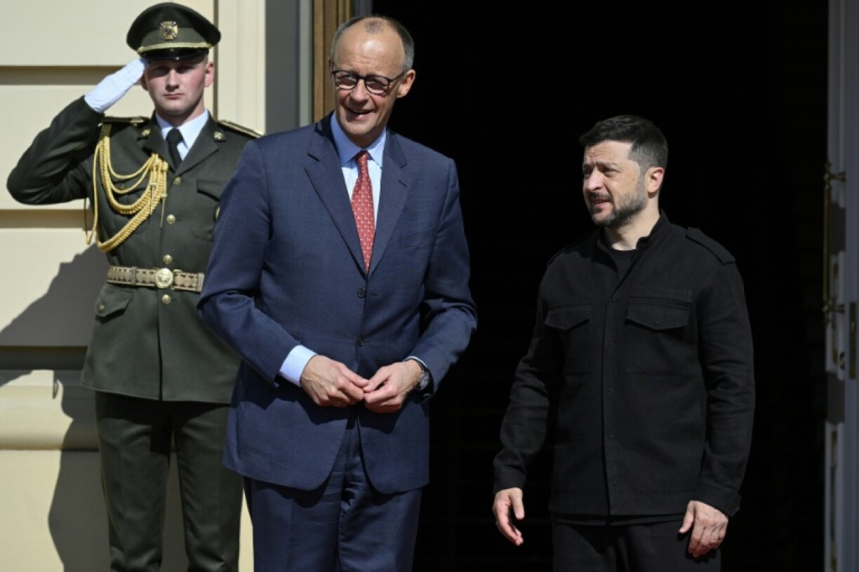 Ukrainian President Volodymyr Zelensky (R) and German Chancellor Friedrich Merz (C), pictured earlier in May, are expected to discuss EU efforts to levy more sanctions on Moscow