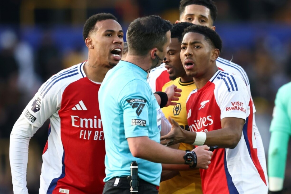 Arsenal's Myles Lewis-Skelly (R) reacts after being sent off at Wolves
