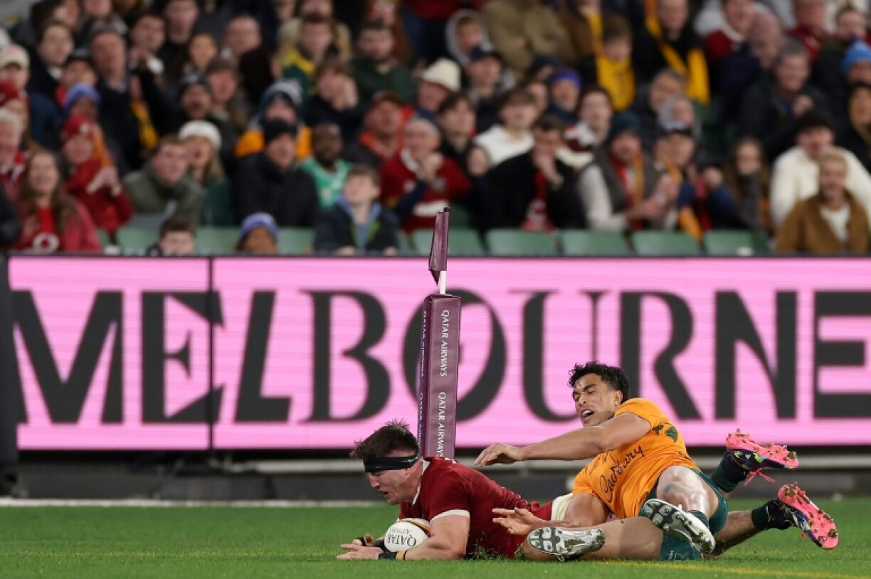 British and Irish Lions' Tom Curry scores a try under pressure from Australia's Joseph-Aukuso Suaalii