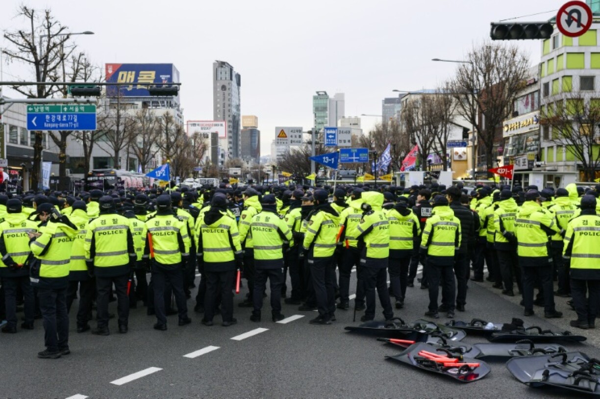Police stand guard while blocking a road as demonstrators in Seoul call for the ouster of South Korea President Yoon Suk Yeol
