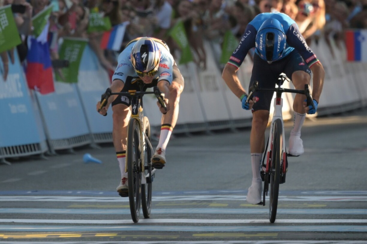 Remco Evenepoel (L) crosses the finish line to win ahead of Giulio Ciccone