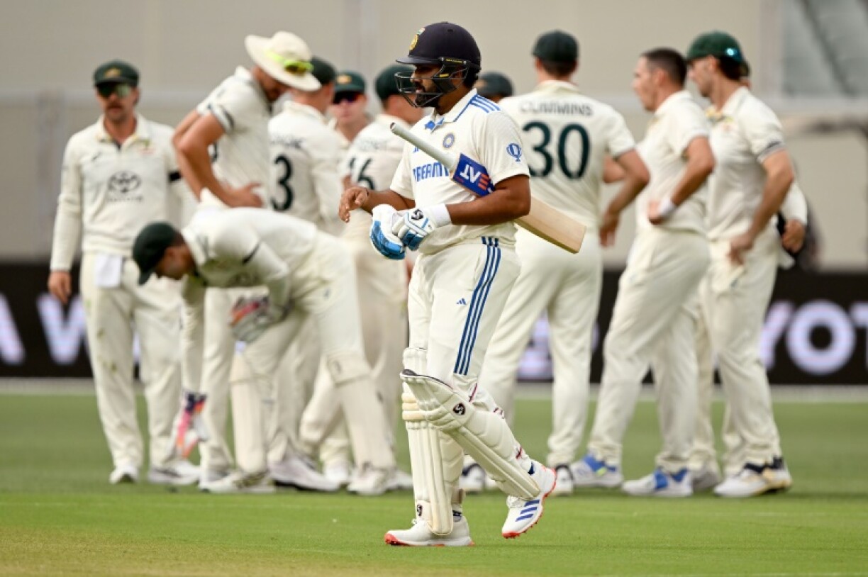 India's captain Rohit Sharma walks off after being dismissed by Australia's Scott Boland
