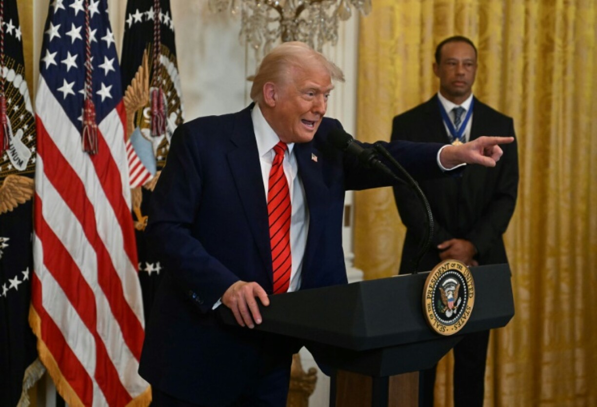 US golf legend Tiger Woods, right watches as President Donald Trump speaks during a Black History Month reception in the White House after they met to discuss the PGA Tour-LIV Golf divide