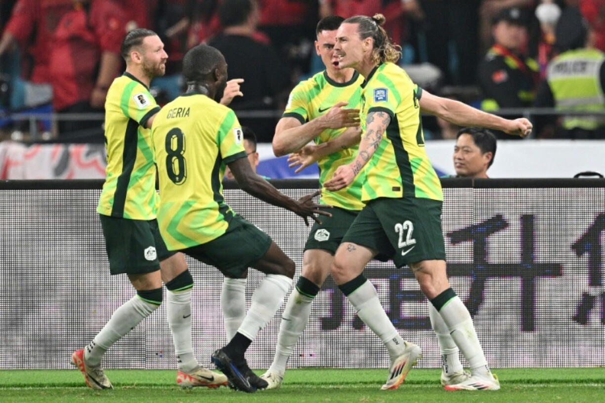 Australia's Jackson Irvine (right) celebrates with teammates after scoring against China in Hangzhou
