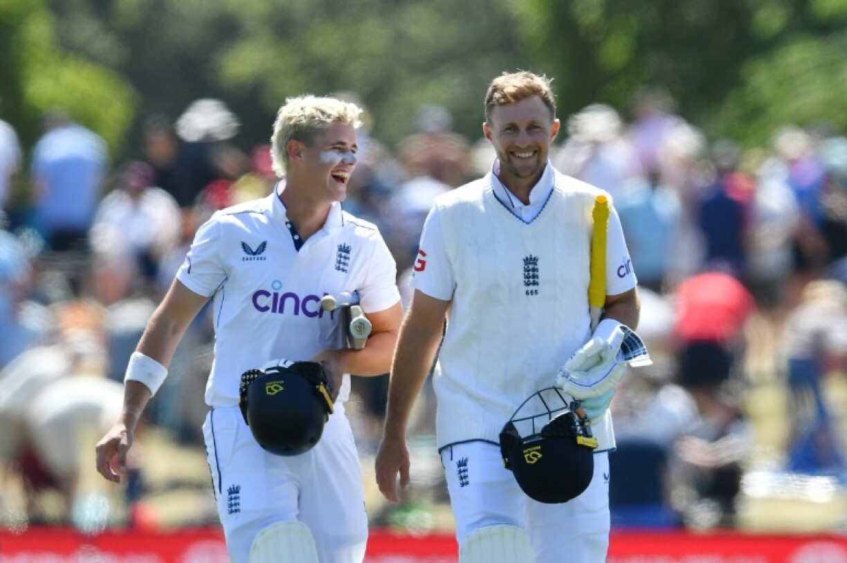 England's Jacob Bethell (L) and Joe Root leave the ground after beating New Zealand in the first Test