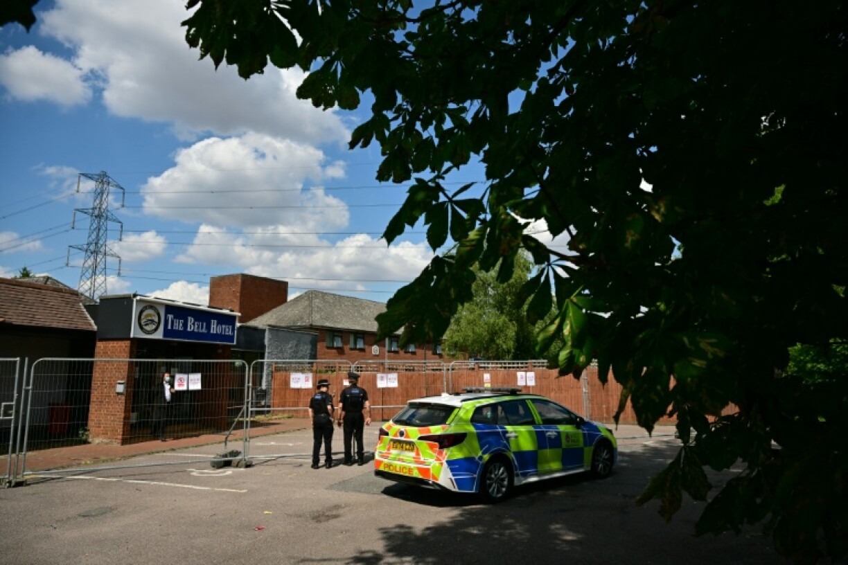Police officers outside The Bell Hotel, Epping, which a UK judge has ordered to be emptied of aslyum-seekers
