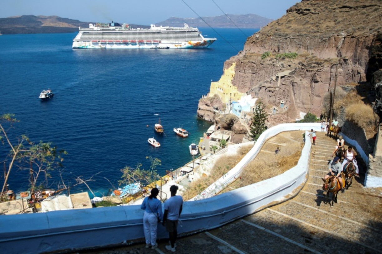 A cruise ship off the Greek island of Santorini, which is among the destinations for which cruise ships will now pay tourist taxes