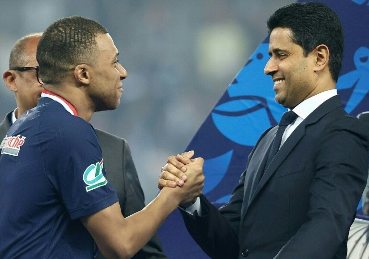 France star Kylian Mbappe (L) and Paris Saint-Germain president Nasser Al-Khelaïfi (R) after the team's French Cup final victory at Lyon on May 25, 2024