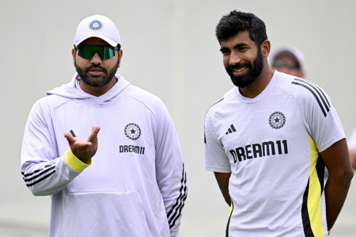 India’s Rohit Sharma (L) chats with teammate Jasprit Bumrah during a practice session ahead of the fifth Test