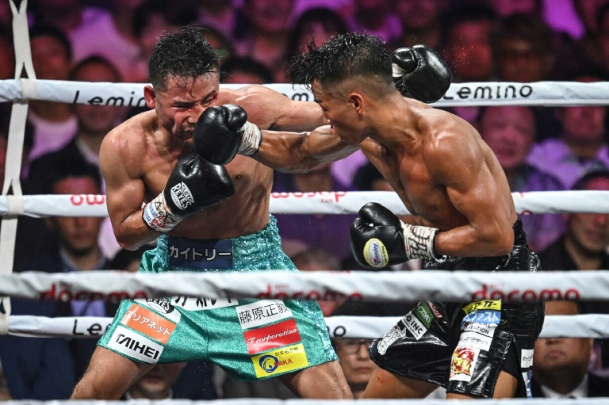 This file photo taken on September 3, 2024 shows the Japanese boxers Yoshiki Takei (R) and Daigo Higa in action