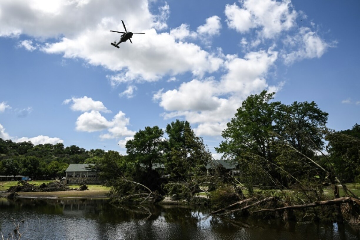 A search-and-rescue helicopter flies over Camp Mystic along the Guadalupe River in Hunt, Texas, where severe flash flooding over the Fourth of July holiday weekend left more than 120 people dead and another 170 missing