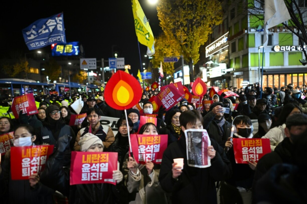 Protesters taking part in a march against South Korea President Yoon Suk Yeol head toward the presidential office in Seoul after his failed bid to institute martial law
