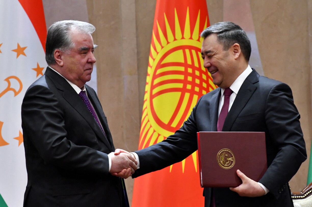 Kyrgyz President Sadyr Japarov and his Tajik counterpart Emomali Rakhmon shake hands during a signing ceremony following their talks at the Yntymak Ordo state residence in Bishkek on March 13, 2025.