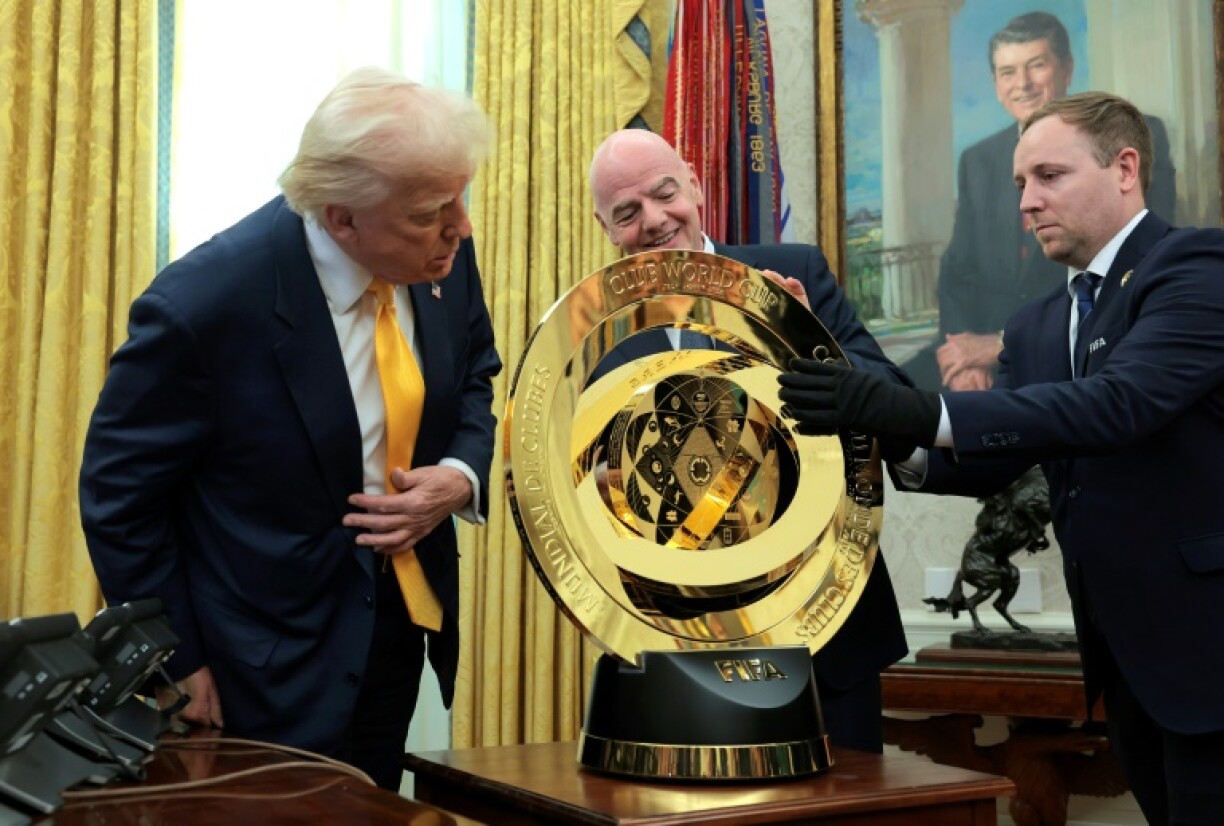 U.S. President Donald Trump and FIFA president Gianni Infantino unveil the Club World Cup trophy in the Oval Office at the White House.