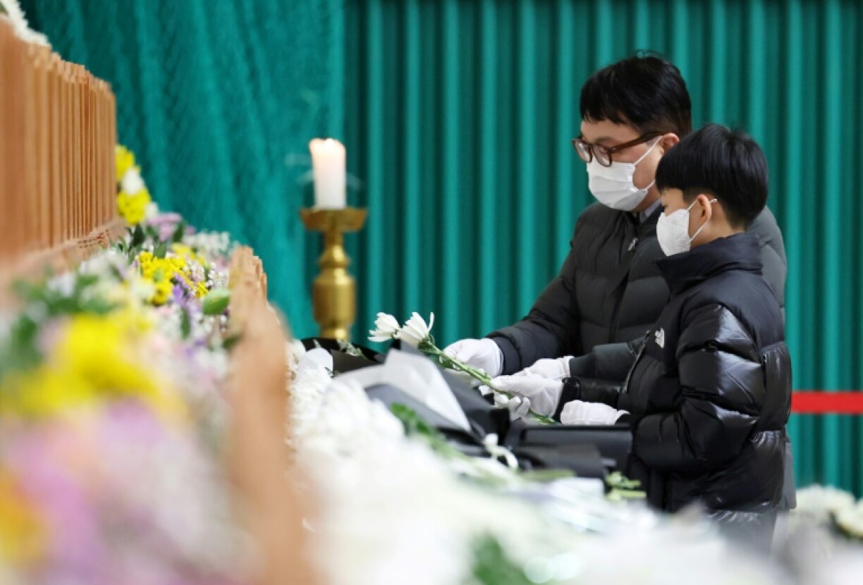 Mourners pay their respects at a memorial altar for victims of the Jeju Air plane crash