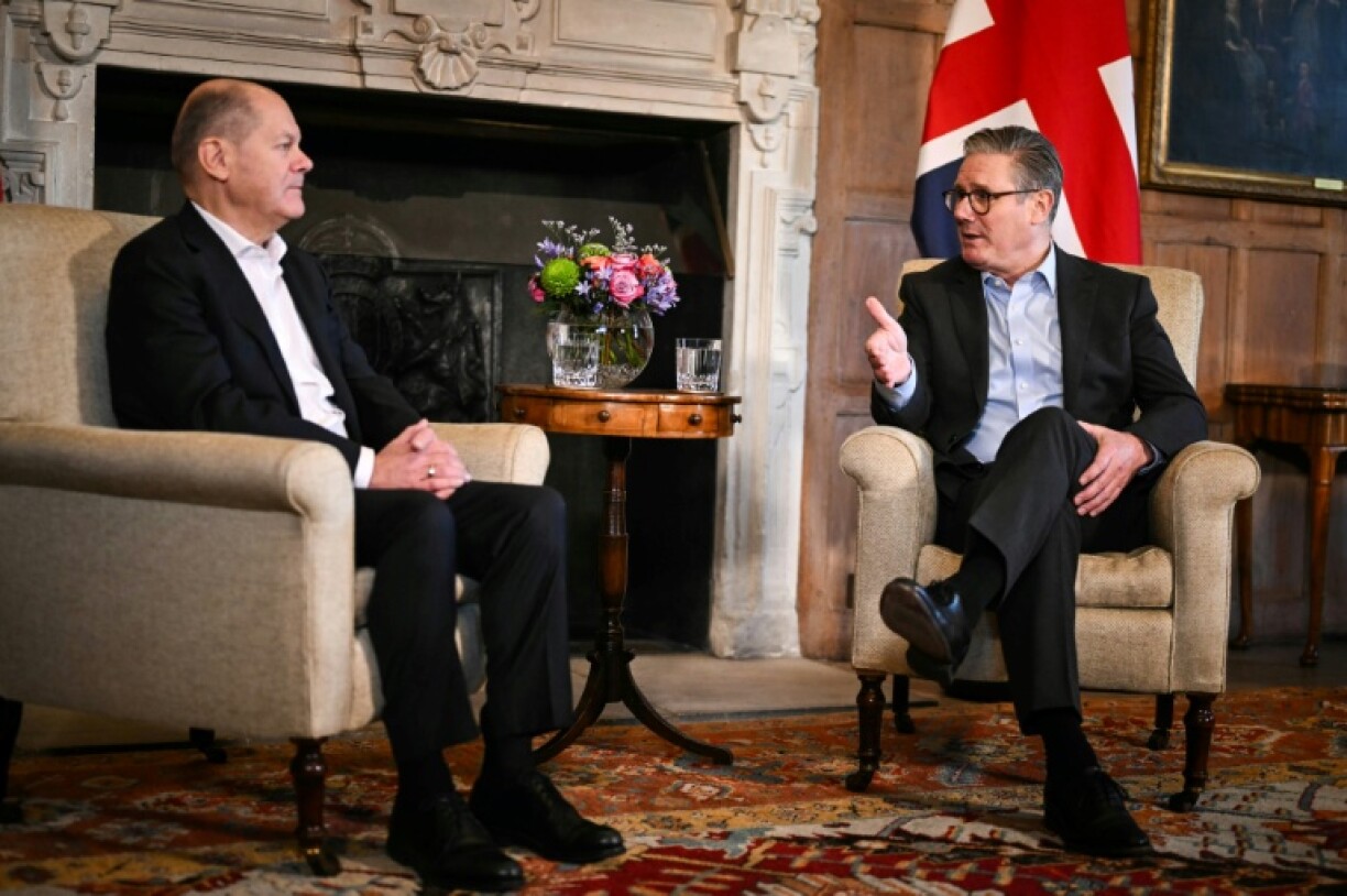UK Prime Minister Keir Starmer (R) speaks with Germany's Chancellor Olaf Scholz during a bilateral meeting at Chequers