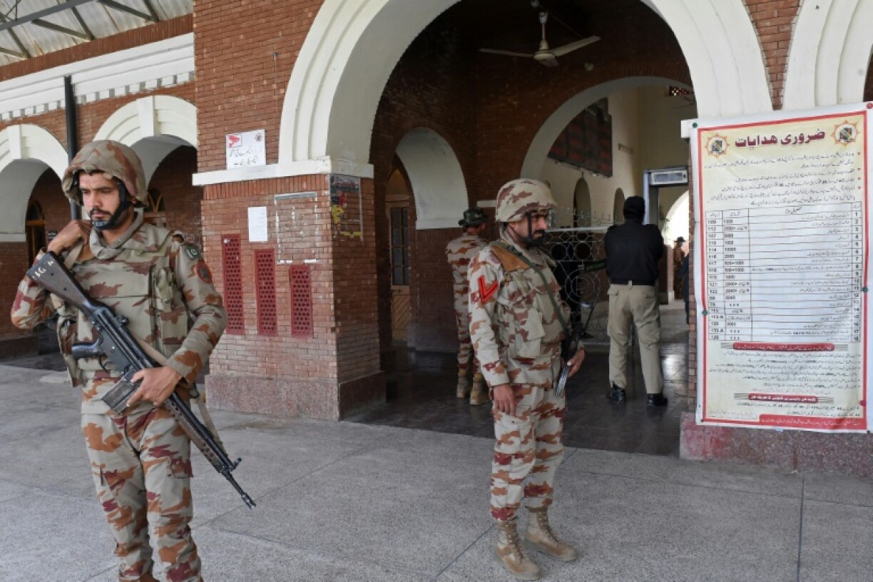 Paramilitary soldiers stand guard at a railway station in Sibi district after separatists attacked a train in the mountainous region and took passengers hostage