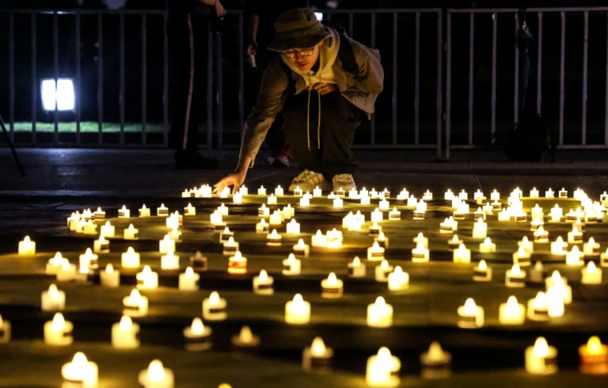 A mourner places a candle at Taipei's Liberty Square to mark the 36th anniversary of China's Tiananmen Square crackdown in 1989