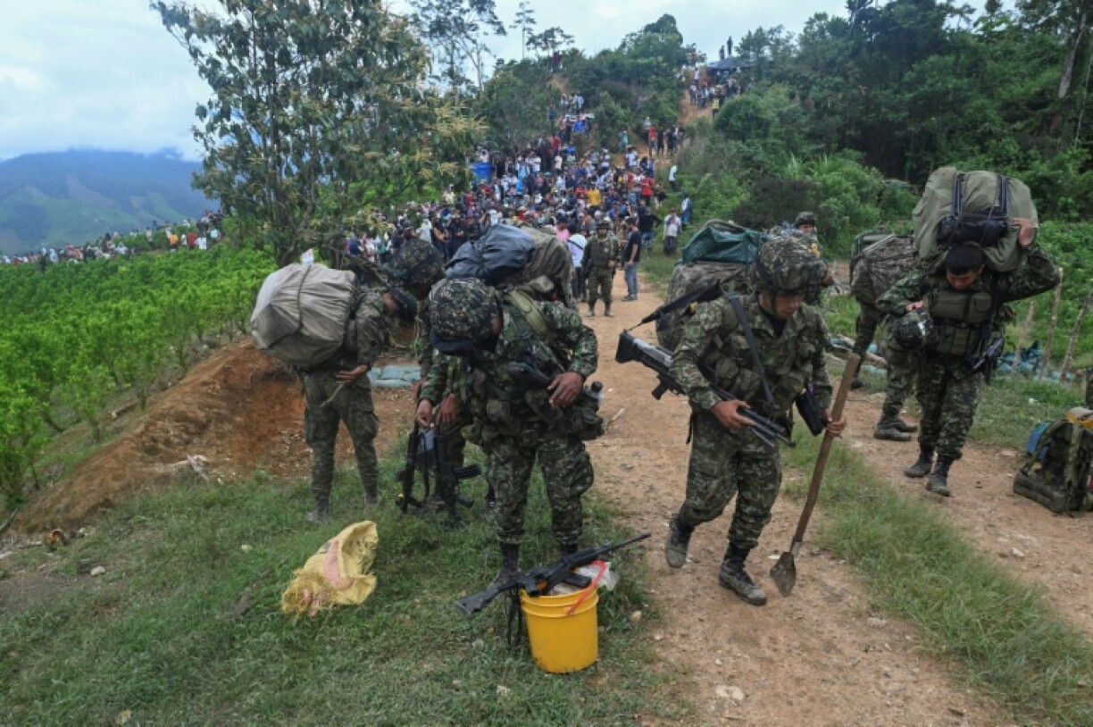 Soldiers depart their military base near El Plateado, Cauca department after harassment by locals