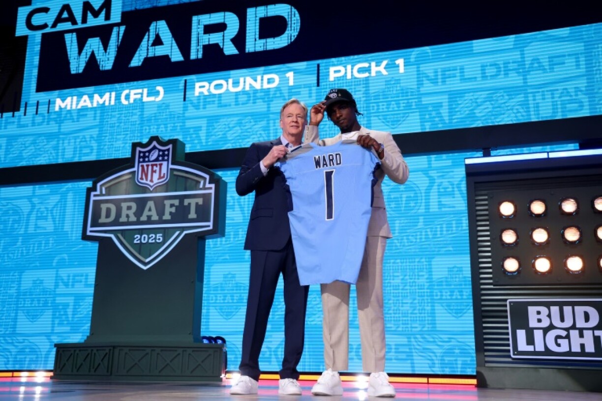 Quarterback Cam Ward, right, poses with NFL commissioner Roger Goodell after being selected first overall by the Tennessee Titans in the NFL Draft