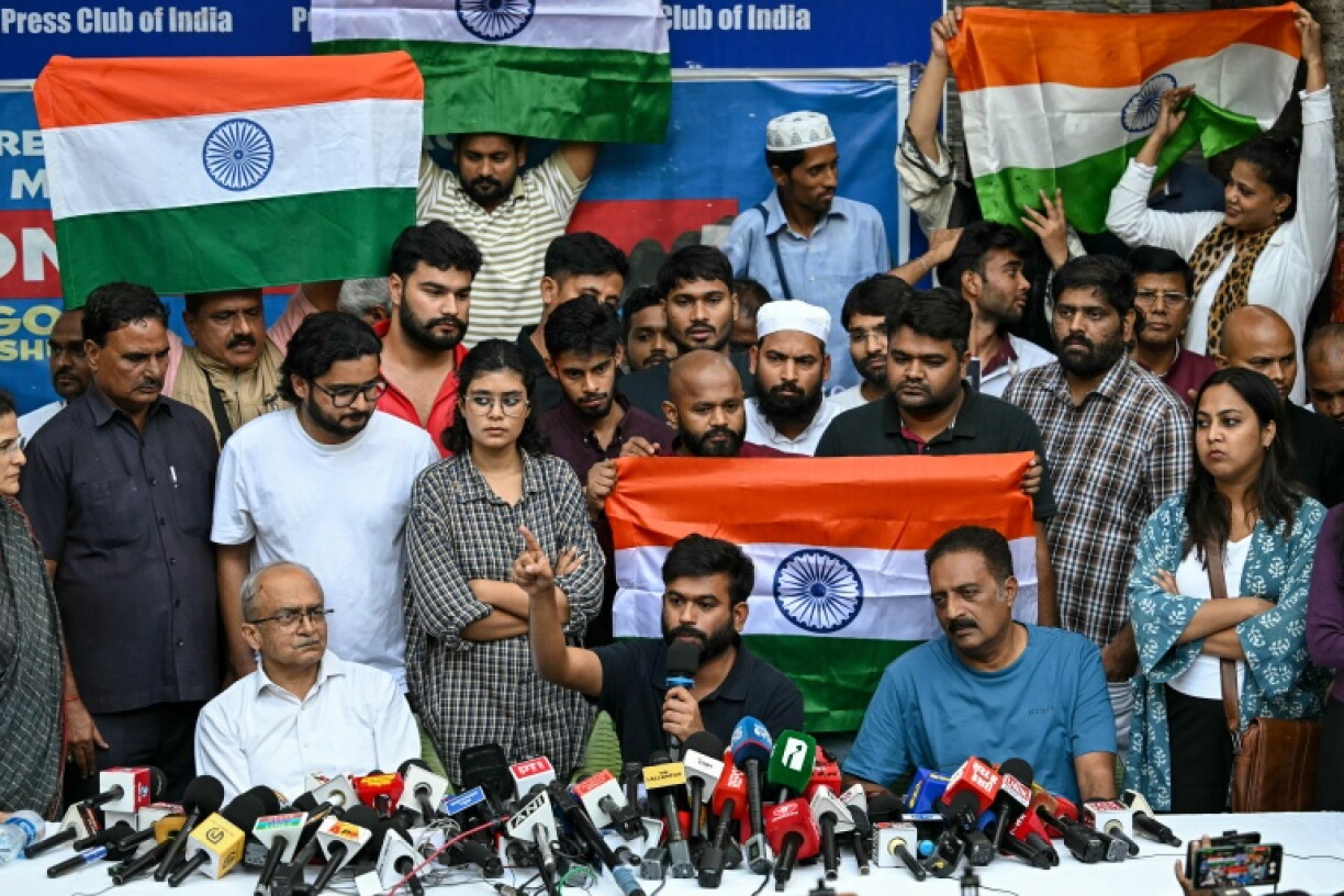 Cockroach Janta Party (CJP) founder Abhijeet Dipke (C) along with Indian actor and activist Prakash Raj (R) and Indian lawyer and activist Prashant Bhushan (L) in New Delhi on October 15, 2026