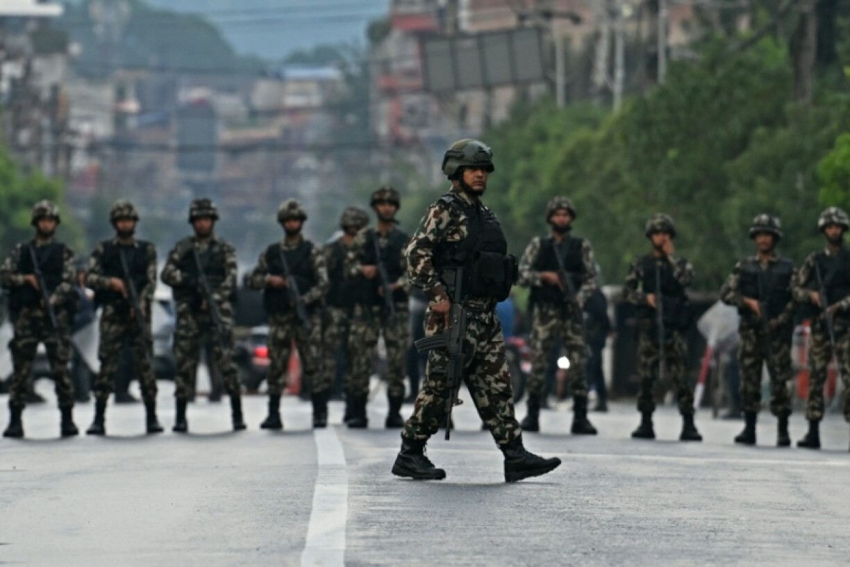 Nepal's army soldiers take their positions to disperse protesters in front of the presidential palace during a curfew imposed to restore law and order in Kathmandu