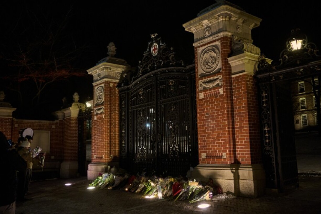 A memorial for the victims of a December 13 mass shooting is seen at the Van Winkle Gates outside Brown University’s campus in Providence, Rhode Island, on December 15, 2025