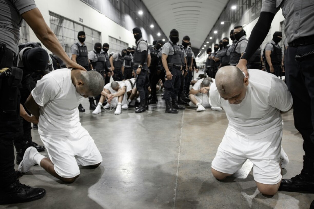 A handout picture released by El Salvador's Presidency press office shows alleged members of the Venezuelan criminal organization Tren de Aragua at the Terrorism Confinement Center