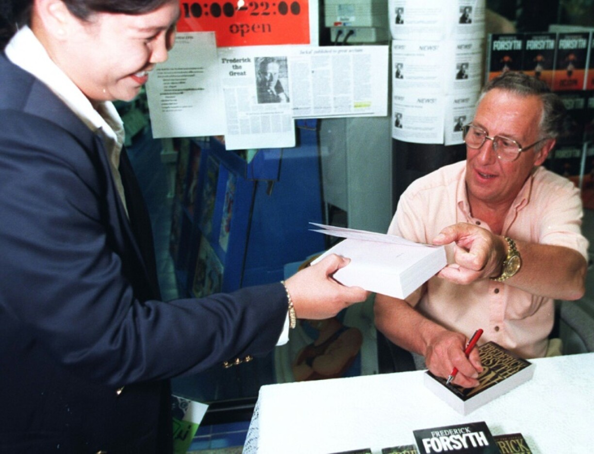 Frederick Forsyth in Bangkok in 1997, signing copies of his novel 'Icon'