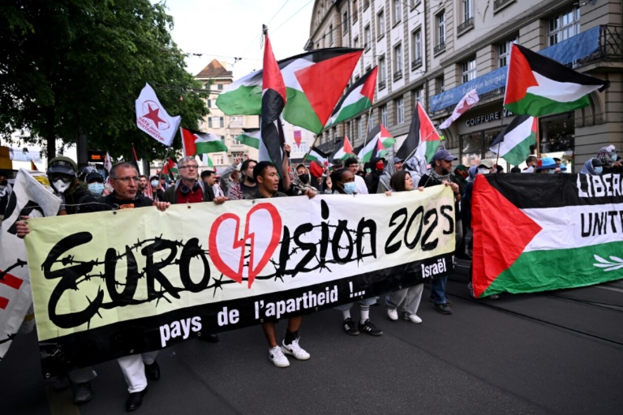 Activists held Palestinian flags and a banner during a demonstration against Israel's participation in the Eurovision Song Contest final