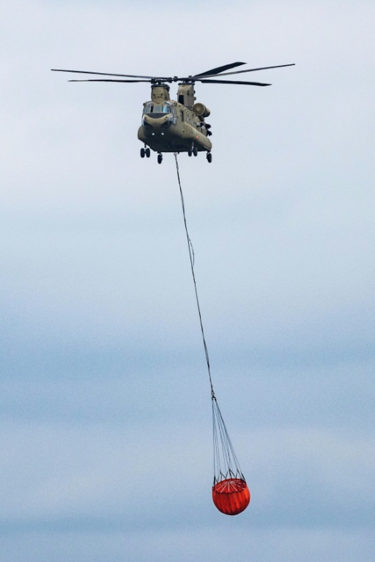 Un hélicoptère Chinook transporte de l'eau pour lutter contre un incendie dans les Hautes Fagnes, un parc naturel dans l'est de la Belgique, mercredi 19 août 2026