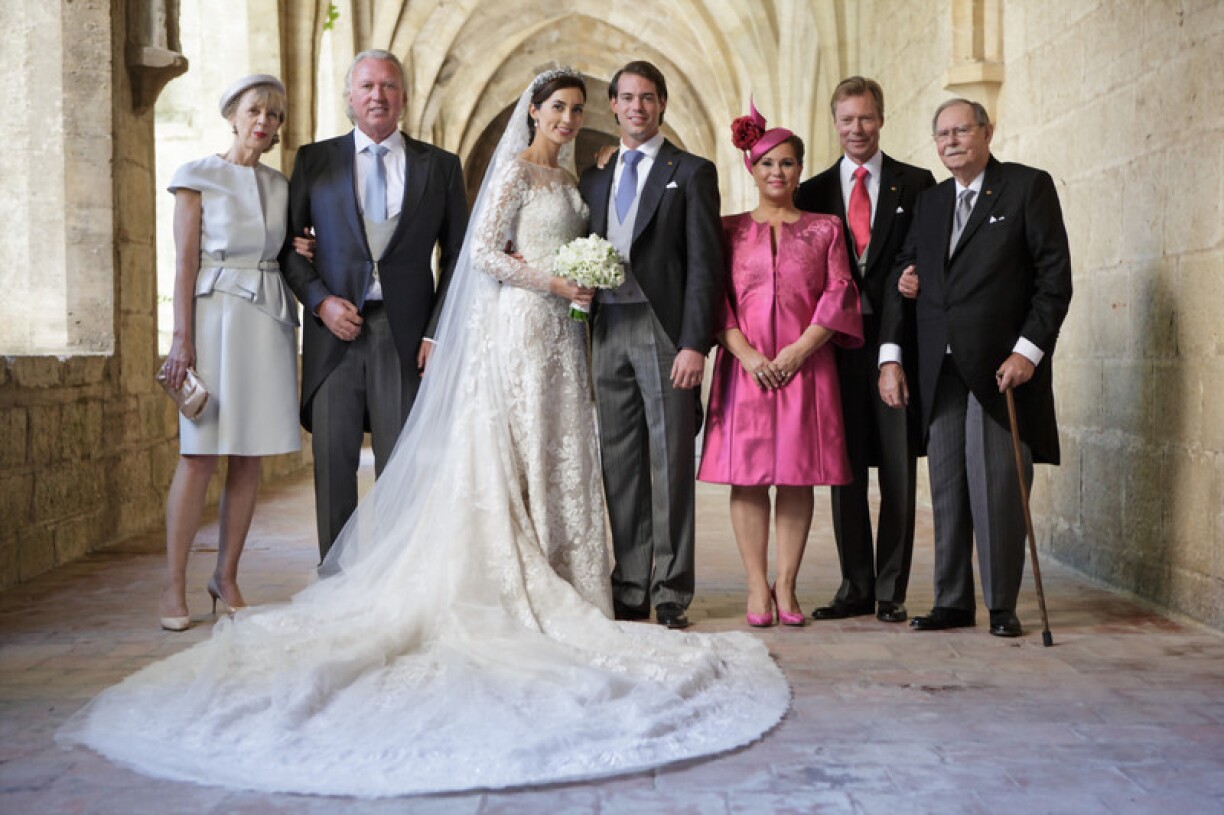 Princess Claire on her wedding day with her parents on the left and her new royal family on the right.